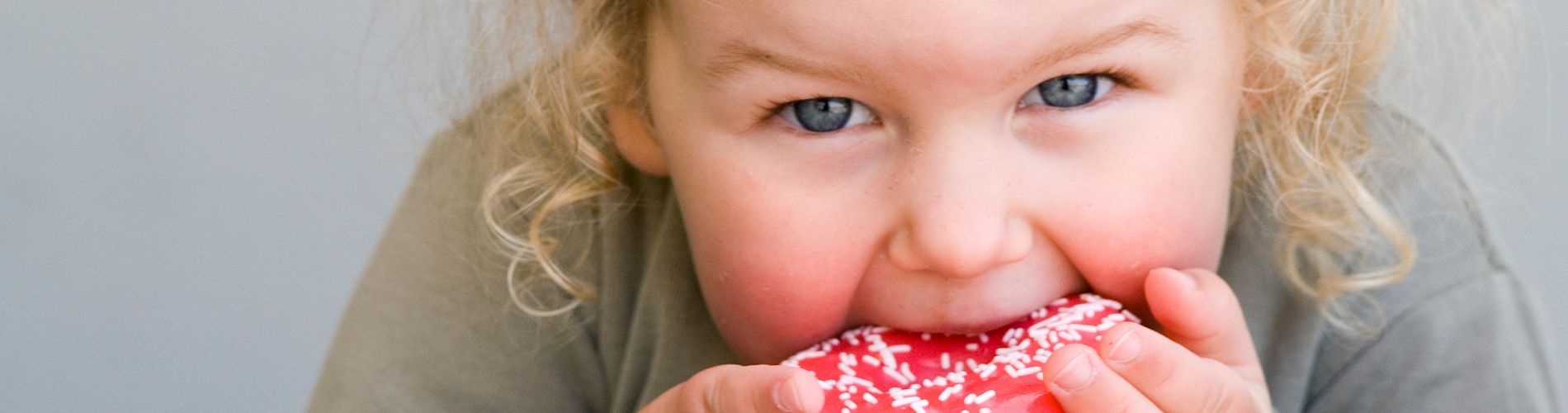 little girl eating a donut
